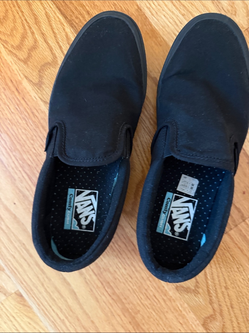 Vans Menโs Black Slip-On Canvas Loafers